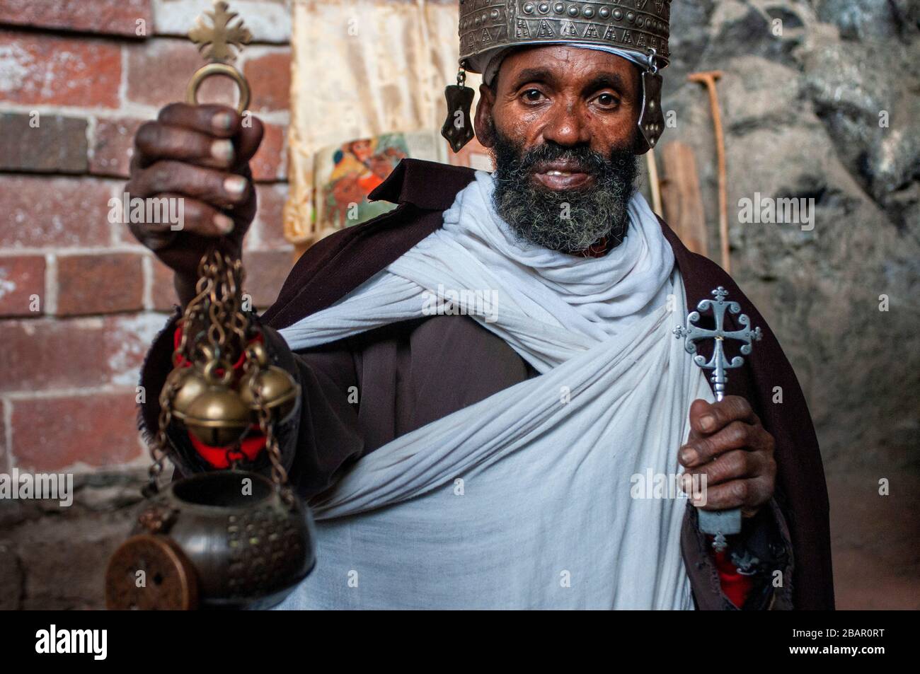 Portrait of an ethiopian orthodox priest holding a cross in nakuto lab cave church, Amhara region, Lalibela, Ethiopia Stock Photo