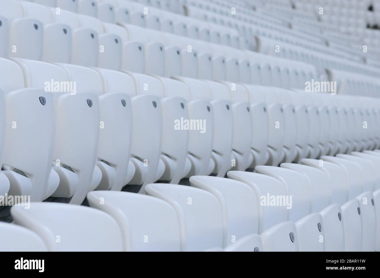 Empty white seats at the american football stadium during isolation period Stock Photo