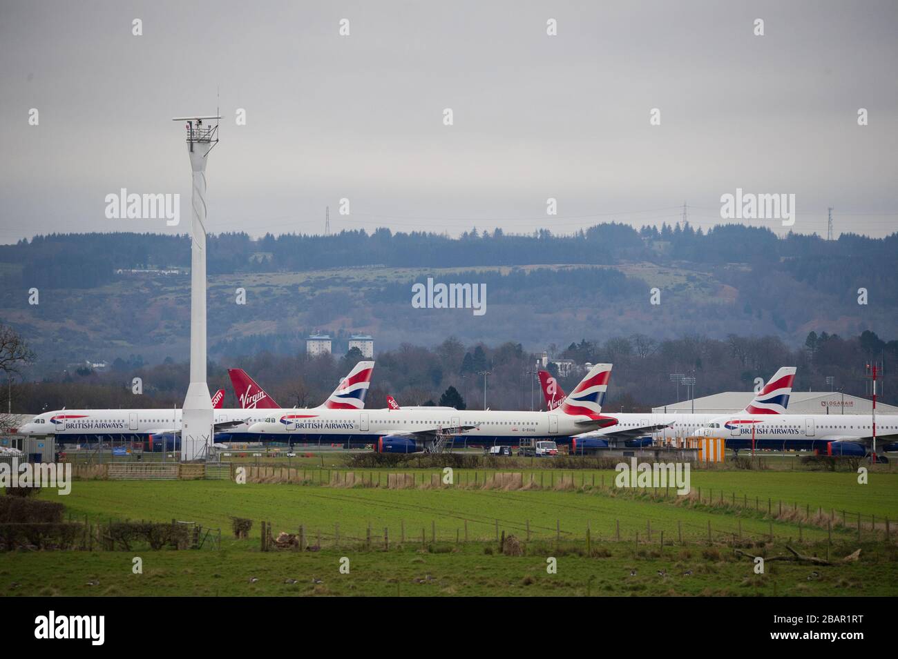 Glasgow, UK. 27 March 2020. Pictured: British Airways Airbus Aircraft stand grounded on the tarmac at Glasgow Airport. The group of Airbus Aircraft comprise of Airbus A321, A320 and one A319 aircraft. Credit: Colin Fisher/Alamy Live News. Stock Photo