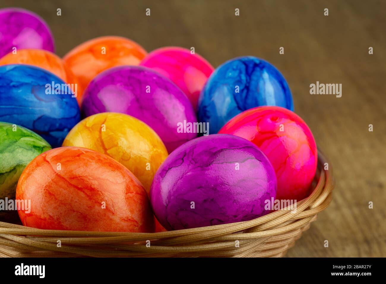 colorful easter eggs in an easter basket closeup Stock Photo