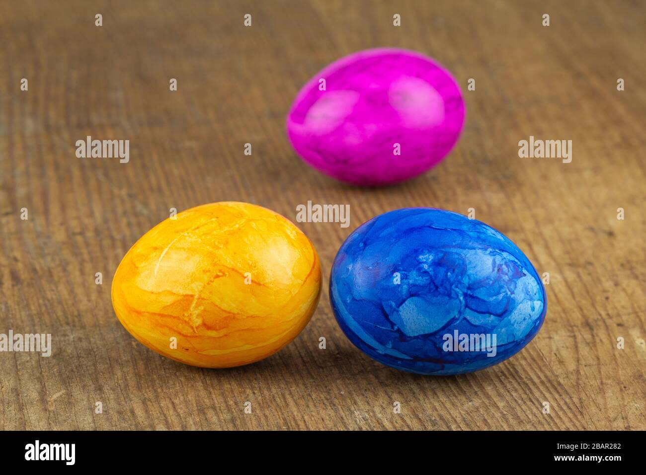 colorful easter eggs on a wooden board Stock Photo