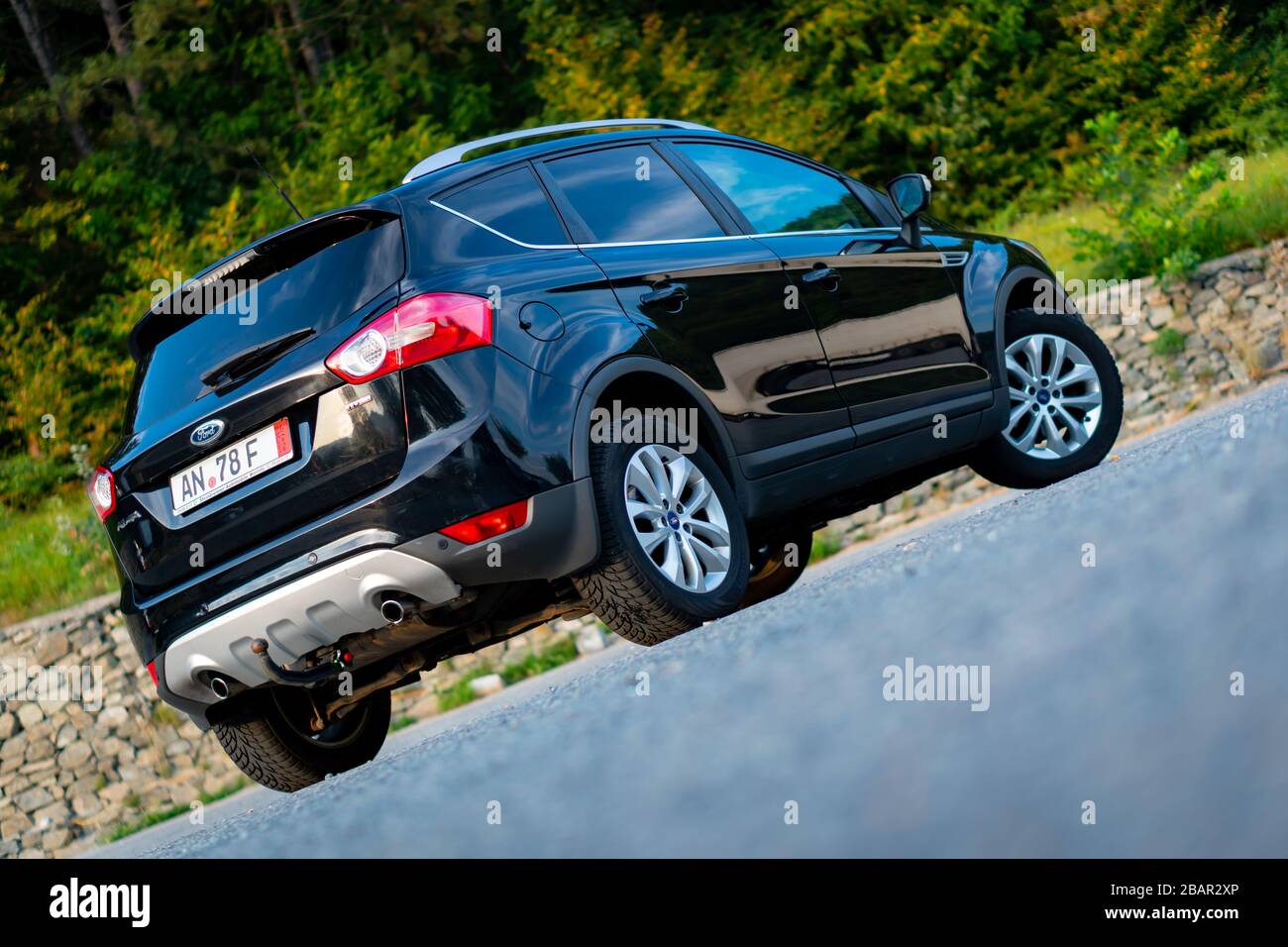 Ford Kuga SUV, black metallic color, panoramic ceiling, 4x4 traction, automatic  transmission, isolated in an empty parking lot, photo shoot Stock Photo -  Alamy