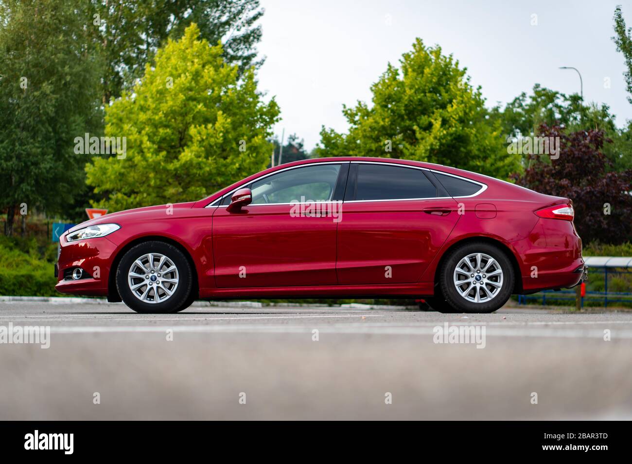 Fil Kalksten Kreta Ford Mondeo MK5 Titanium trim, in Ruby red coloud, sedan, photosession in  an empty parking lot. Isolated car, nice photos Stock Photo - Alamy