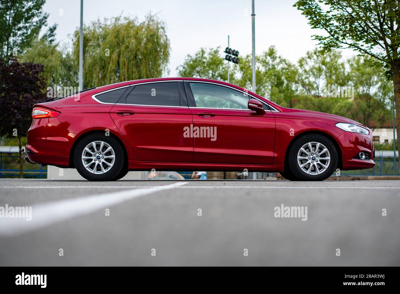 Ford Mondeo MK5 Titanium trim, in Ruby red coloud, sedan, photosession in an empty parking lot. Isolated car, nice photos Stock Photo