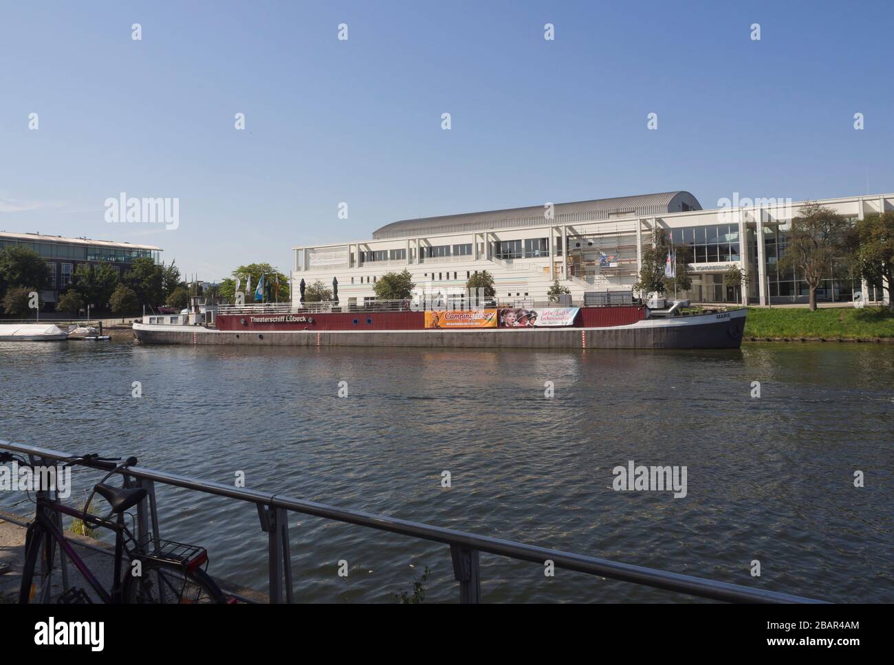 The Music- and congress hall behind the  theater-boat, Theaterschiff in Lübeck Germany Stock Photo