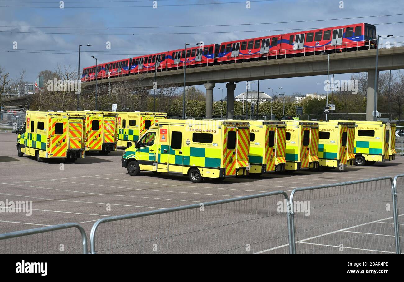 Ambulances at the ExCel centre in London which is being made into a temporary hospital - the NHS Nightingale hospital, comprising of two wards, each of 2,000 people, to help tackle coronavirus. Stock Photo