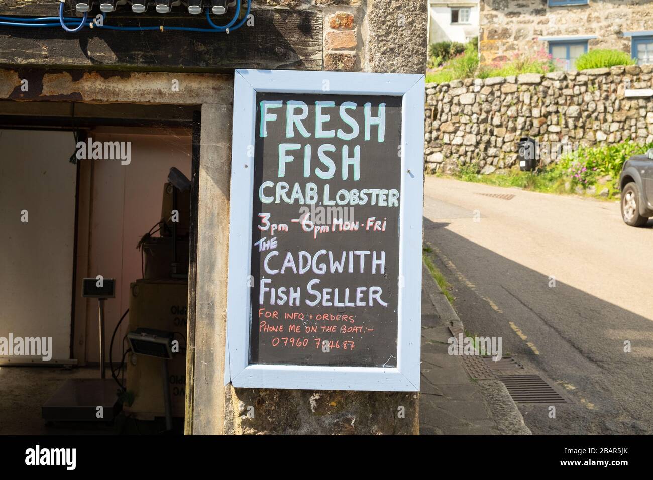 Traditional old blackboard sign outside fish shop fresh fish, the fish seller, in the small