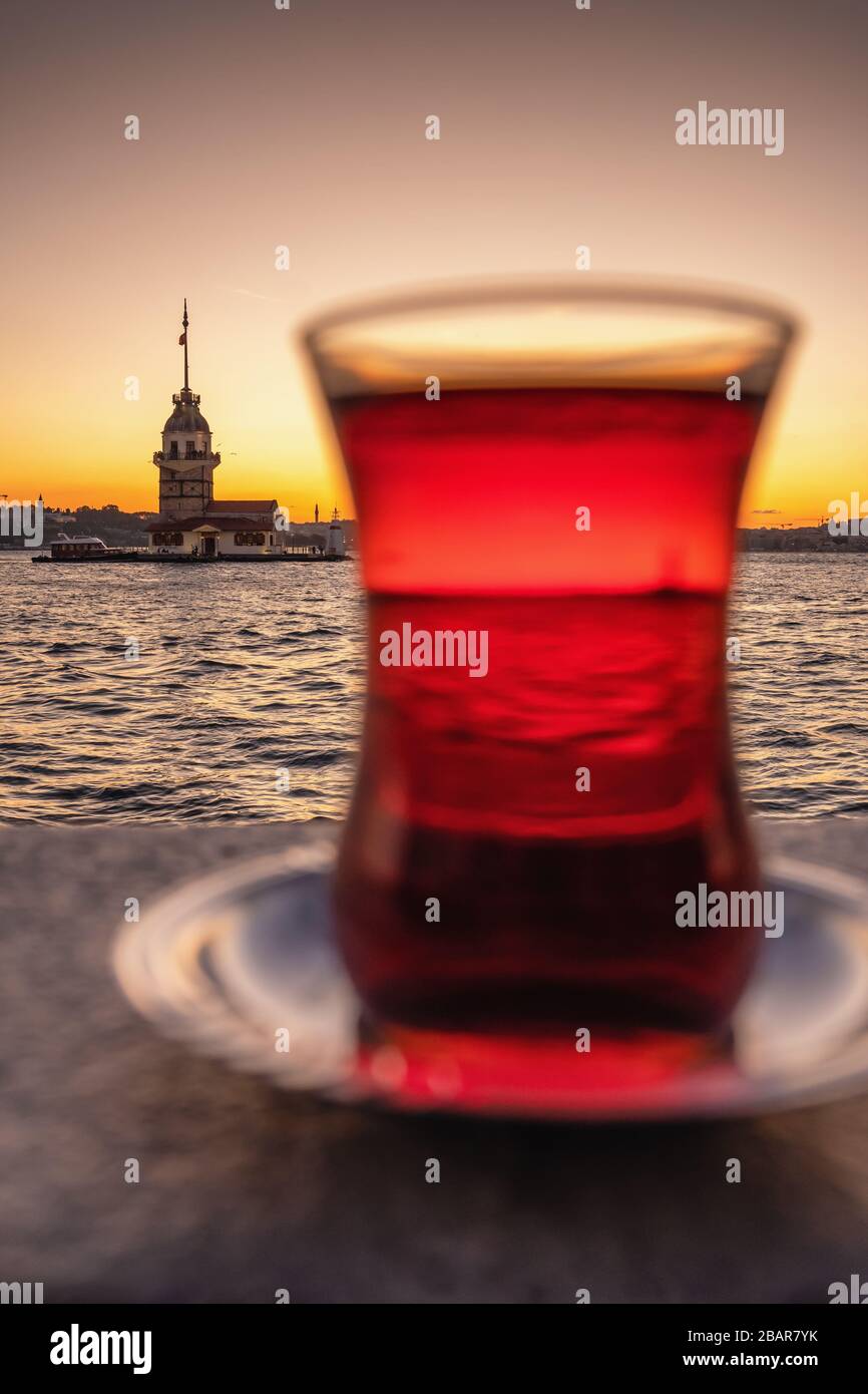Traditional turkish tea in a glass with Maiden Tower at background in Istanbul, Turkey Stock Photo