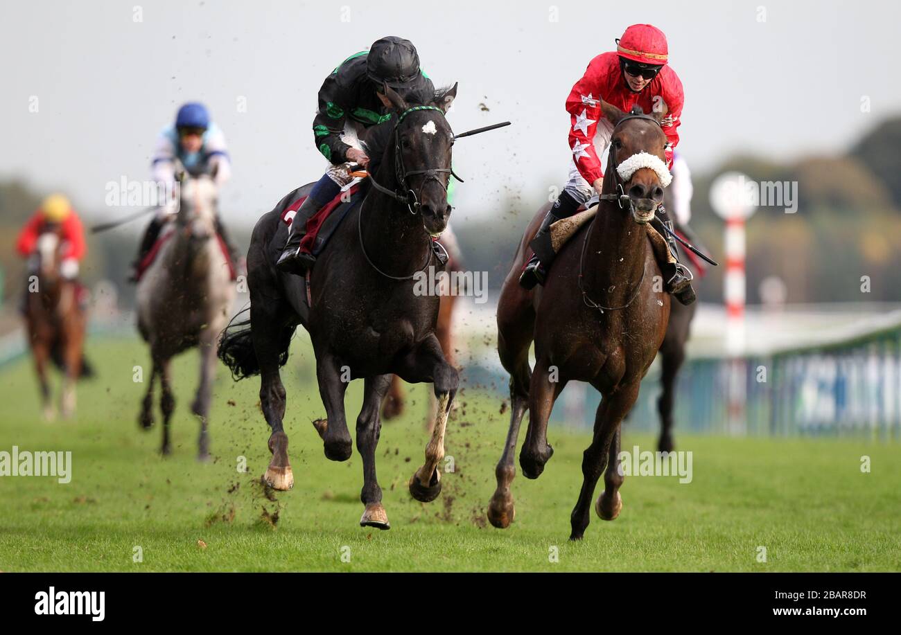 Geordie Man (green and black silks) ridden by Ryan Moore comes home to win The Haydock Park's Rio Carnival Christmas Parties maiden stakes from second placed Butterfly McQueen (red silks) ridden by David Probert Stock Photo