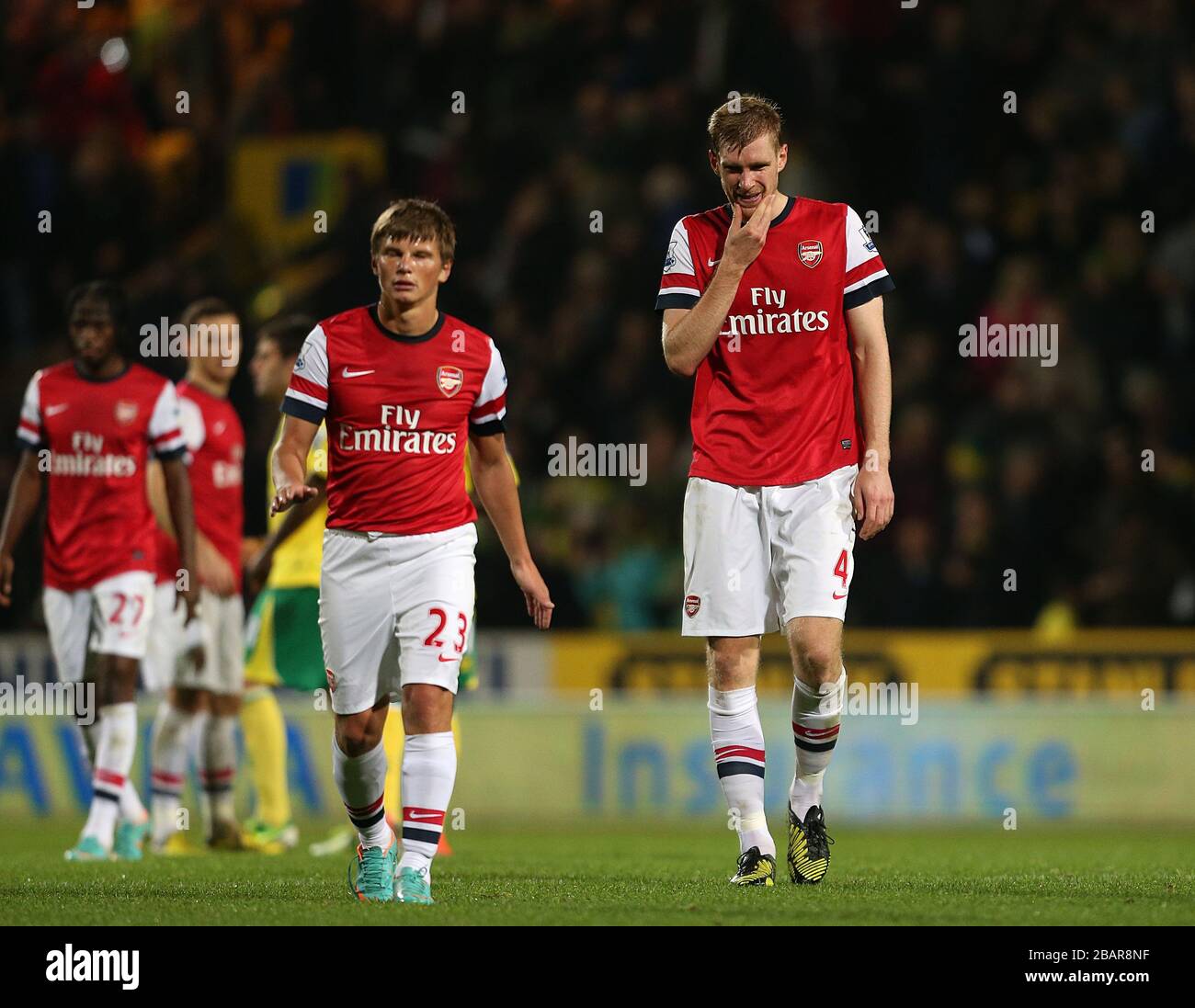 Arsenal's Per Mertesacker (right) and Andrey Arshavin walk off the pitch  dejected after the final whistle Stock Photo - Alamy