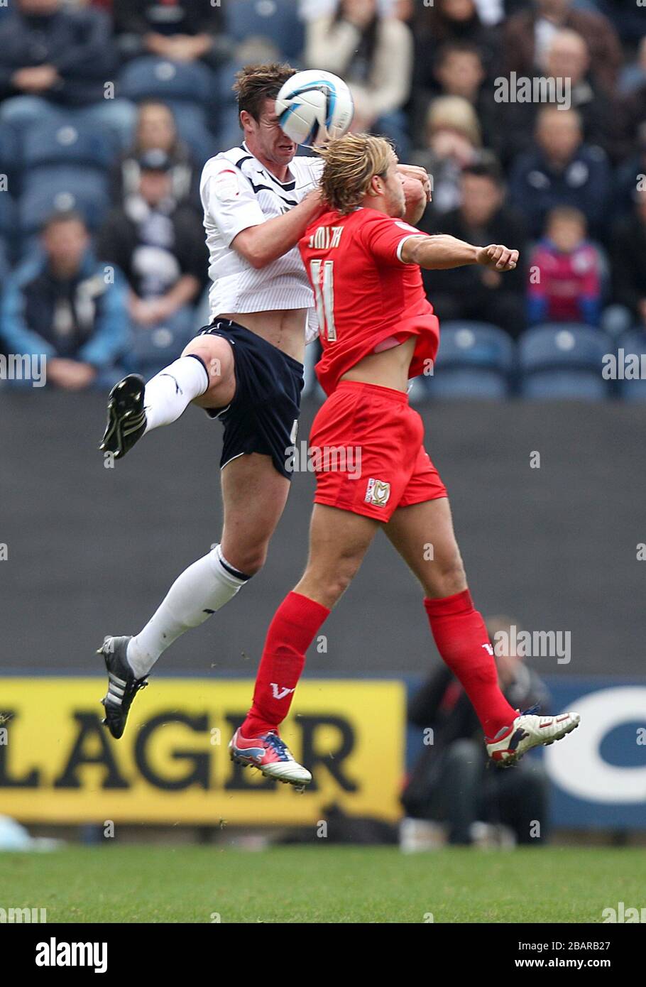 Preston North End's Paul Huntington (left) and Milton Keynes Dons' Alan Smith battle for the ball in the air Stock Photo