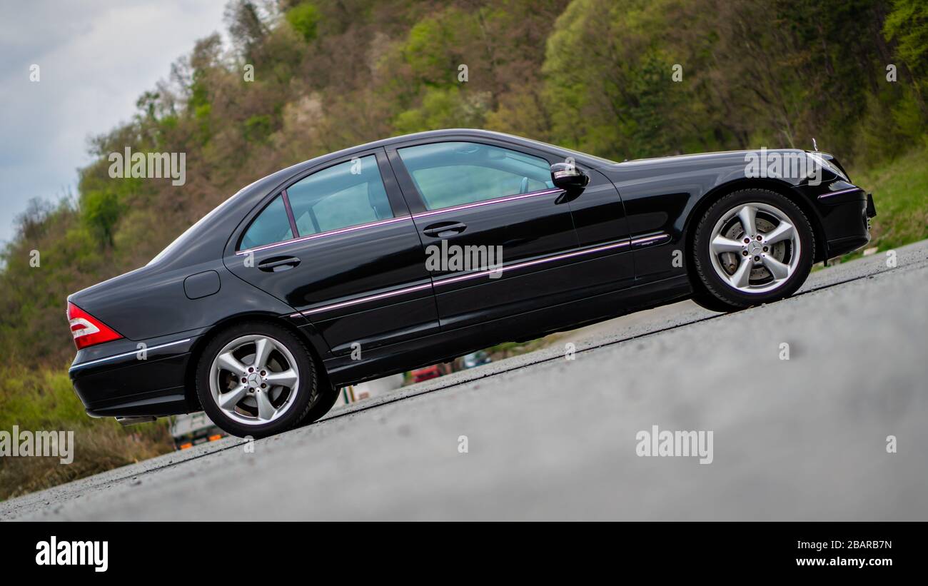Mercedes Benz C Class, model W203 - year 2004, Avantgarde equipment, AMG  Alloy wheels, driver side corner with steered wheels, vented disc brakes,  18 Stock Photo - Alamy
