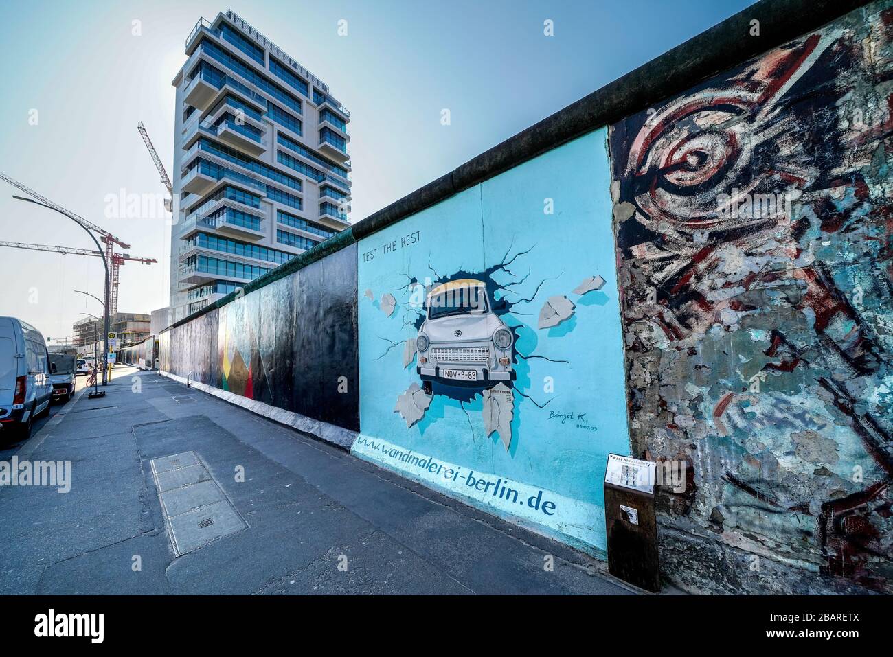 Berlin, Deutschland. 26th Mar, 2020. 26.03.2020, the East Side Gallery monument on the longest surviving section of the Berlin Wall in Muhlenstrasse between Berlin Ostbahnhof and Oberbaumbrucke along the Spree in Berlin-Friedrichshain. She presents a permanent open-air gallery with works by various artists. Here is the work "TEST THE REST" by the artist Birgit Kinder, which shows a Trabant coming through the wall through you. --- For editorial use only! --- Only for editorial use! --- | usage worldwide Credit: dpa/Alamy Live News Stock Photo