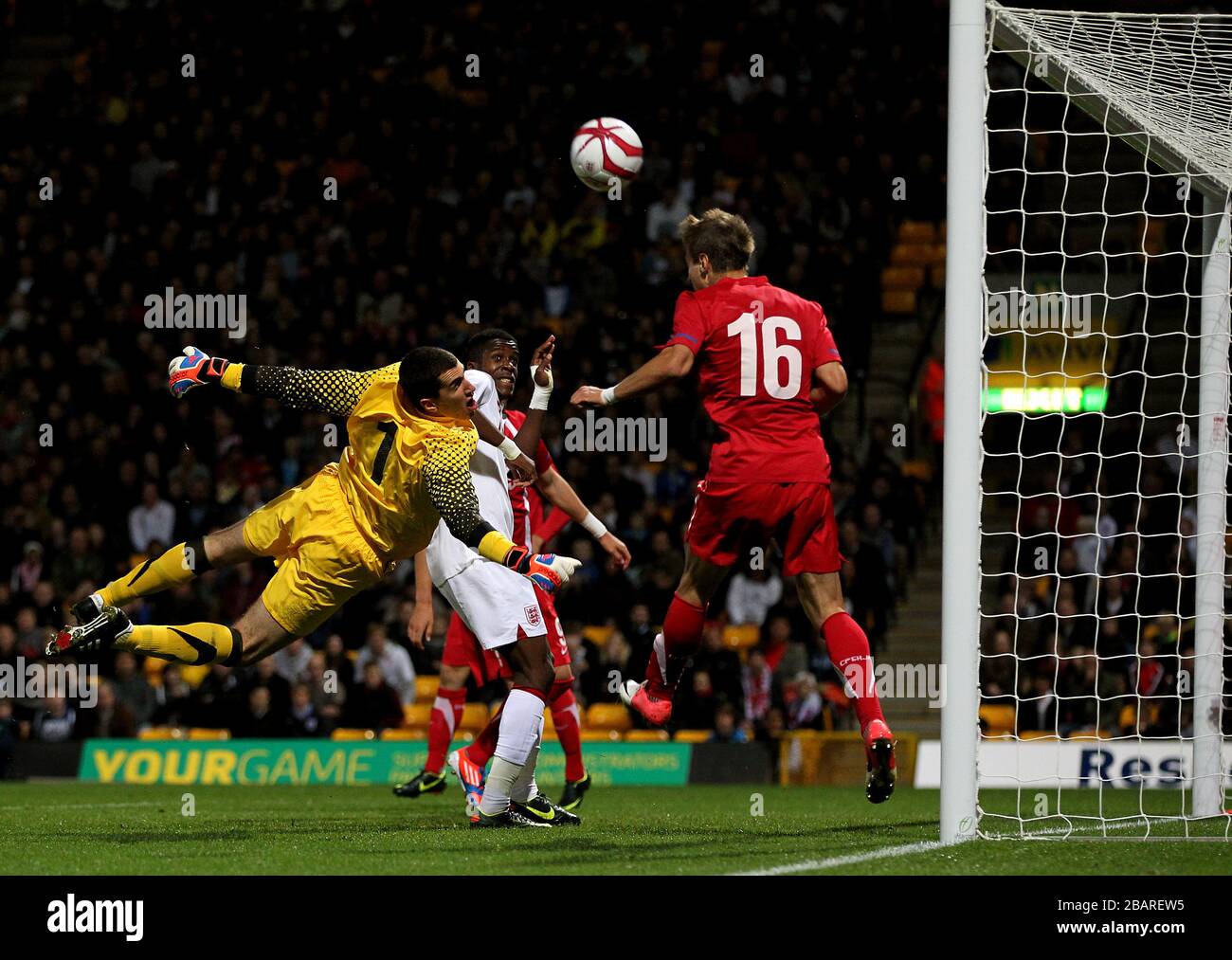 England's Wilfried Zaha sees his shot tipped over the bar by Serbia goalkeeper Branimir Aleksic Stock Photo