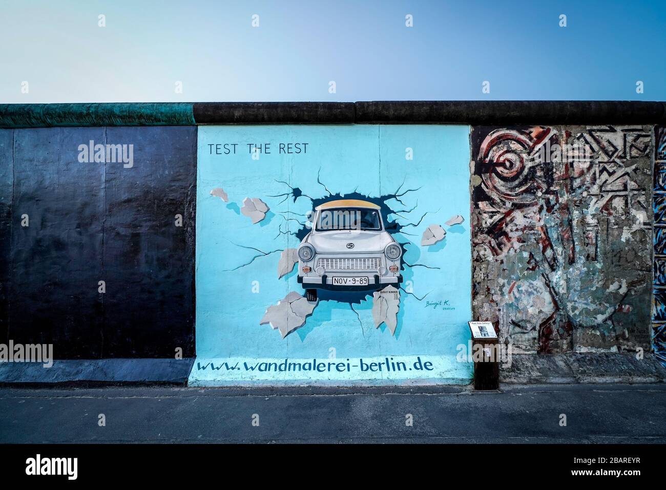 Berlin, Deutschland. 26th Mar, 2020. 26.03.2020, the East Side Gallery monument on the longest surviving section of the Berlin Wall in Muhlenstrasse between Berlin Ostbahnhof and Oberbaumbrucke along the Spree in Berlin-Friedrichshain. She presents a permanent open-air gallery with works by various artists. Here is the work "TEST THE REST" by the artist Birgit Kinder, which shows a Trabant coming through the wall through you. --- For editorial use only! --- Only for editorial use! --- | usage worldwide Credit: dpa/Alamy Live News Stock Photo