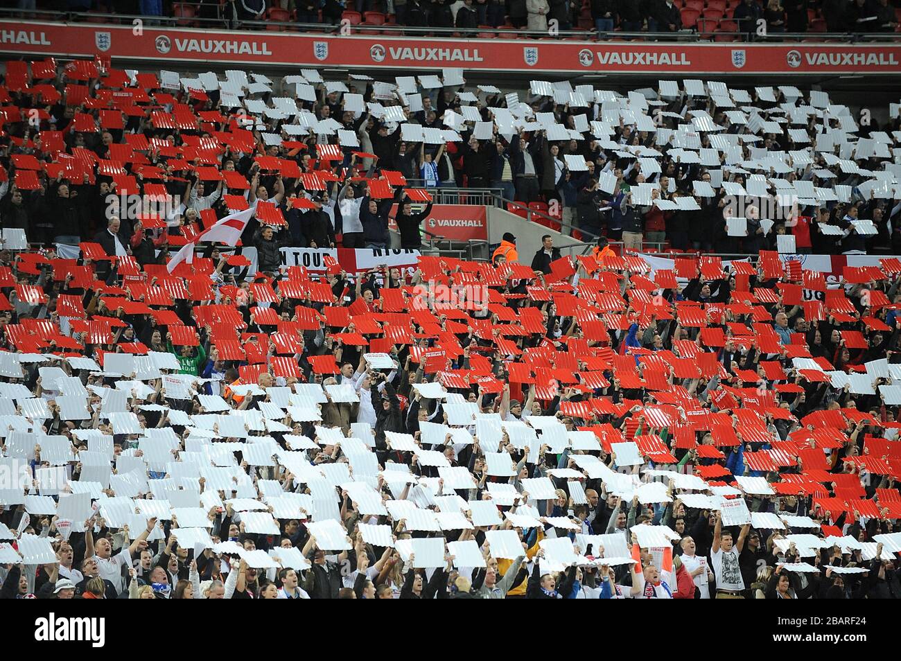England fans hold up coloured cards in the stands to create a giant St George's flag before the game Stock Photo