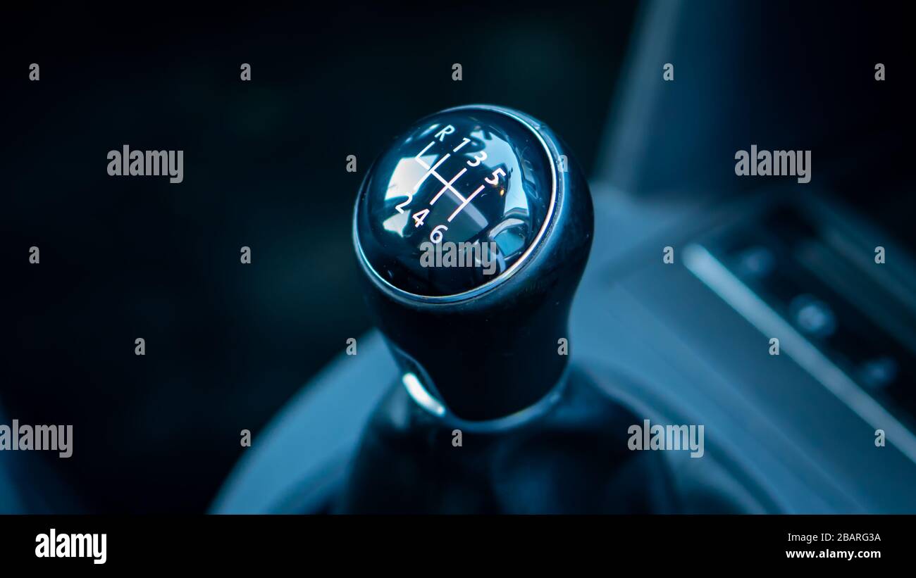 Inside car dashboard view.Detailed close-up photo of manual transmission knob/lever in neutral position.Leather upholstery,6 gear transmission/reverse Stock Photo