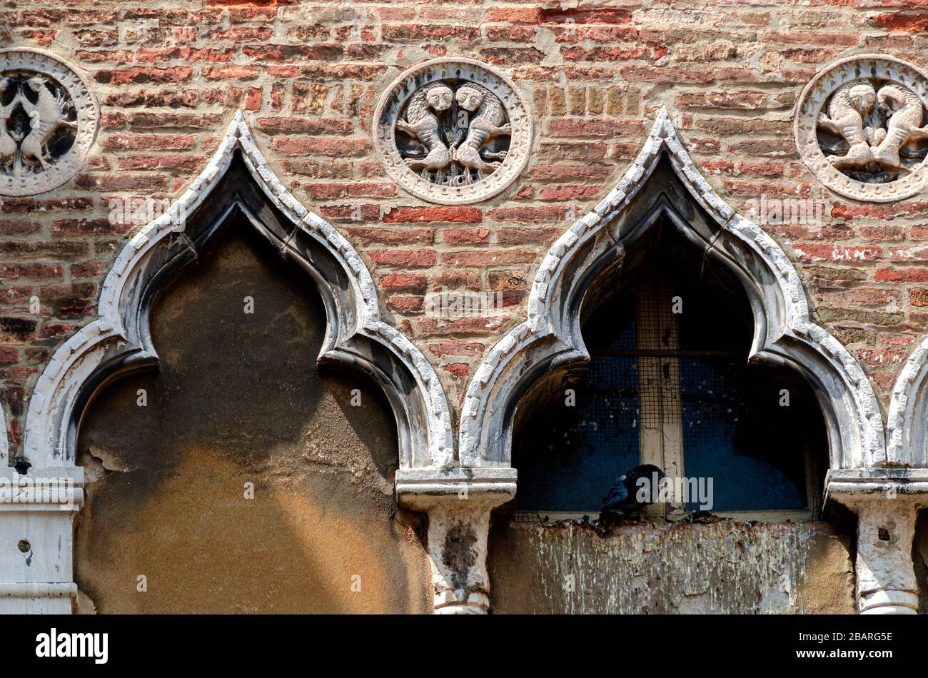 Old walls of Venice with the coat of arms Stock Photo