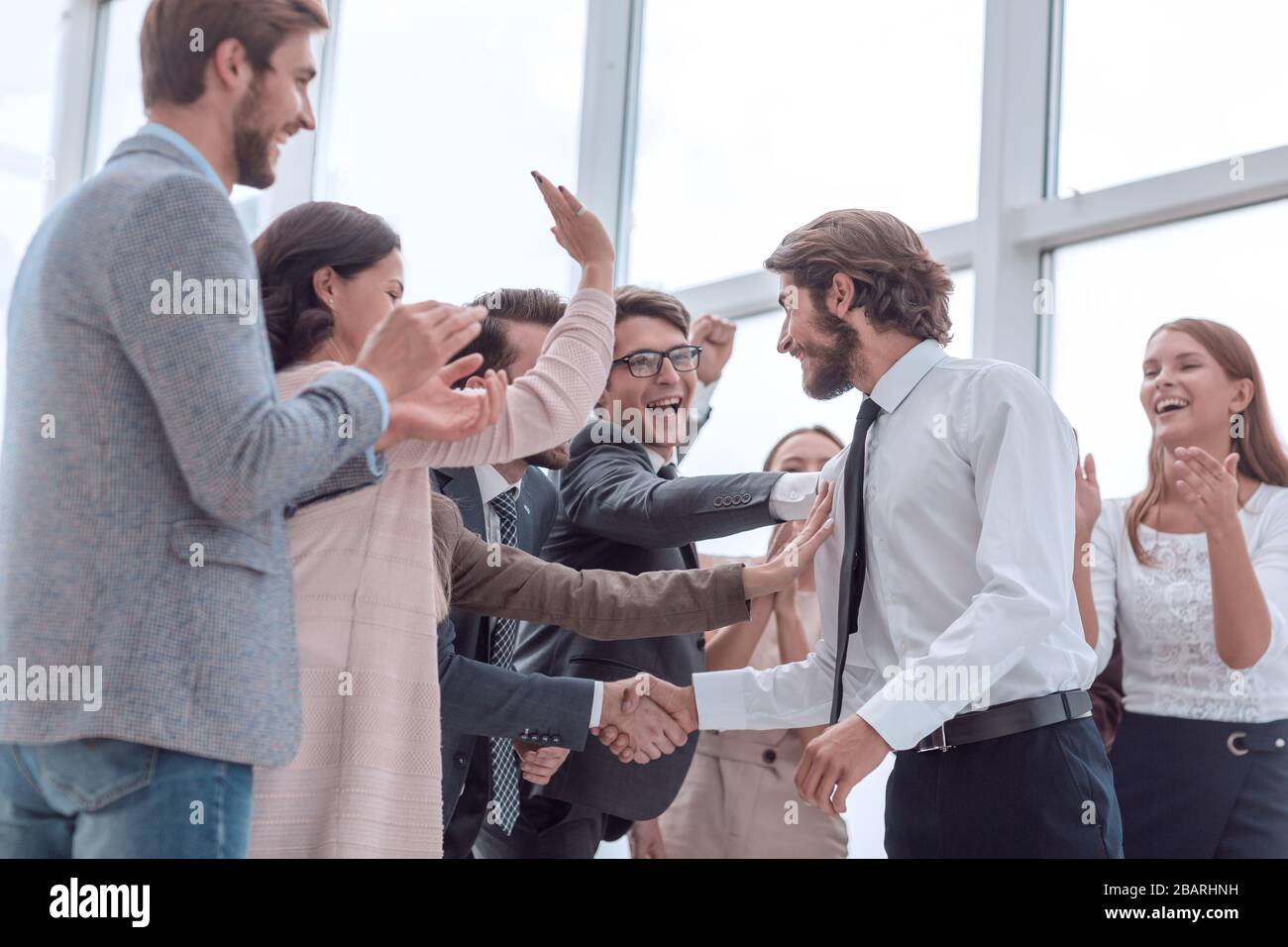corporate group of employees congratulating each other on the victory ...
