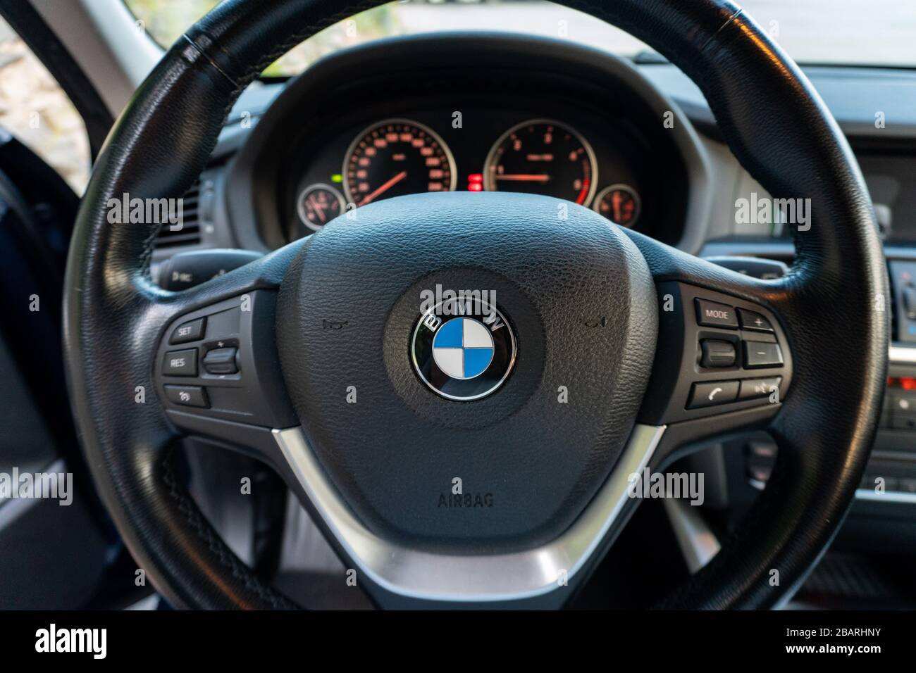 BMW steering wheel close up - detailed photo of instrument cluster, switches, commands, dashboard inside german iconic car Stock Photo
