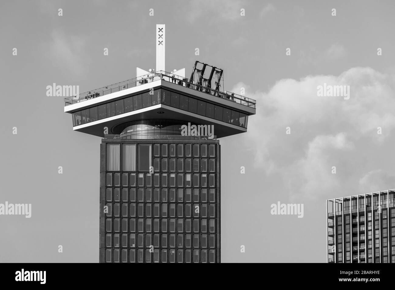 Low angle greyscale shot of a tall historic building under a cloudy sky ...