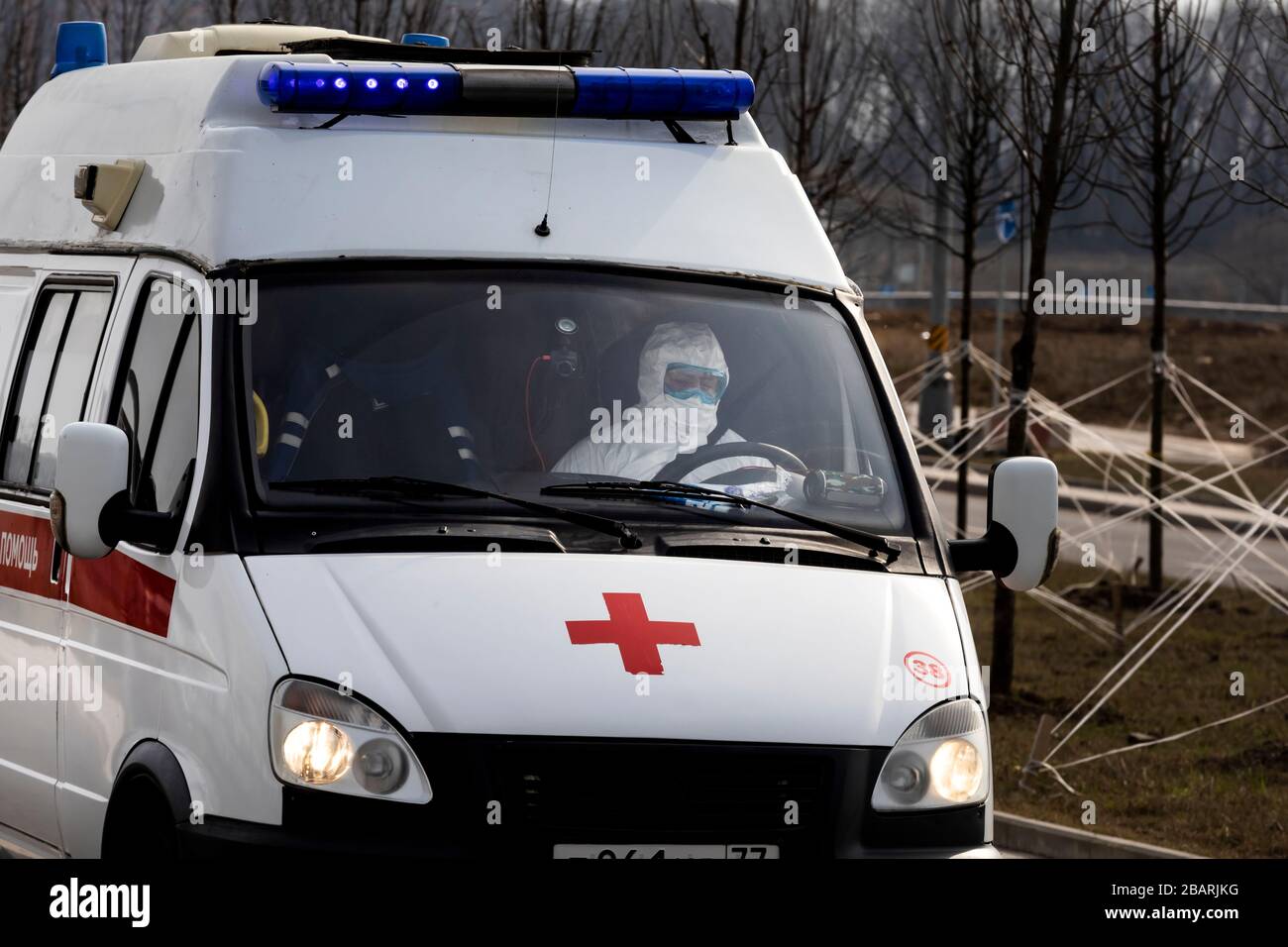 Moscow, Russia. 29th Mar, 2020. A paramedic, wearing protective suits, drive an ambulance near the Novomoskovsky multi-speciality medical centre in Kommunarka, Novomoskovsky Administrative District, during the coronavirus pandemic of the COVID-19 Stock Photo