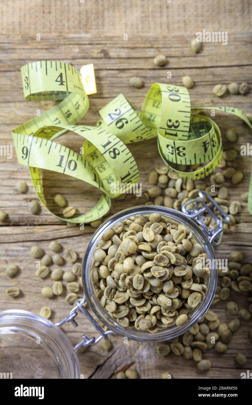 Weight loss and green coffee. Green coffee beans and yellow measure