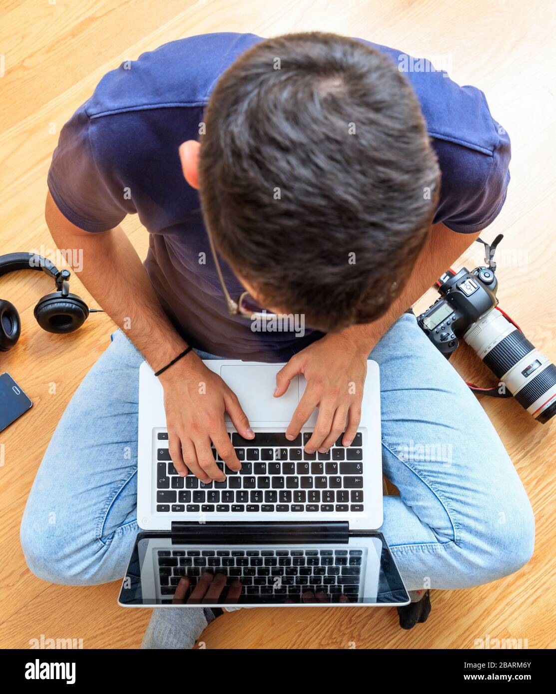 Home office, remote work. Young man working with a computer laptop. Telecommute, teleworking, work from home, making use of the Internet, email, and t Stock Photo