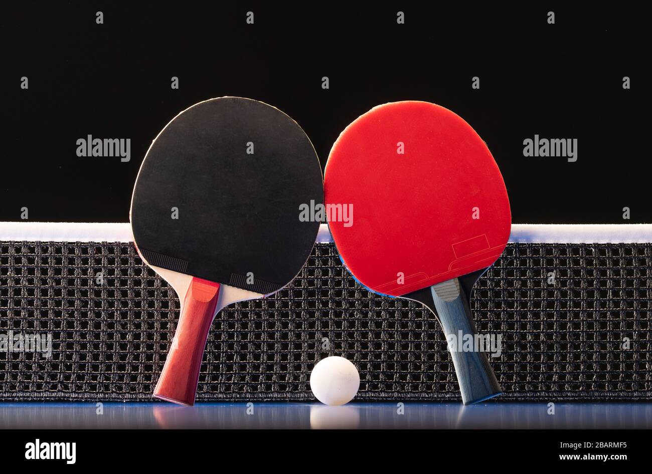 Two Table Tennis Rackets Two table tennis rackets and balls on a blue table with net Stock Photo ...