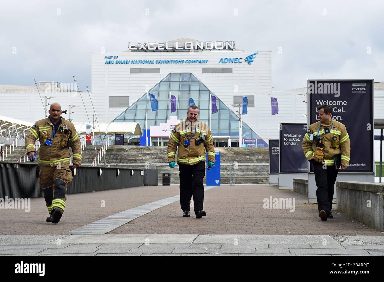Members of the London Fire Brigade at the ExCel centre in London which is being made into a temporary hospital - the NHS Nightingale Hospital - comprising of two wards, each of 2,000 people, to help tackle coronavirus. Stock Photo