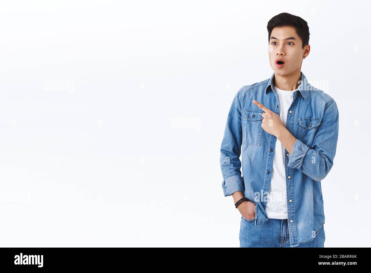 Portrait of impressed, fascinated asian guy seeing something super cool