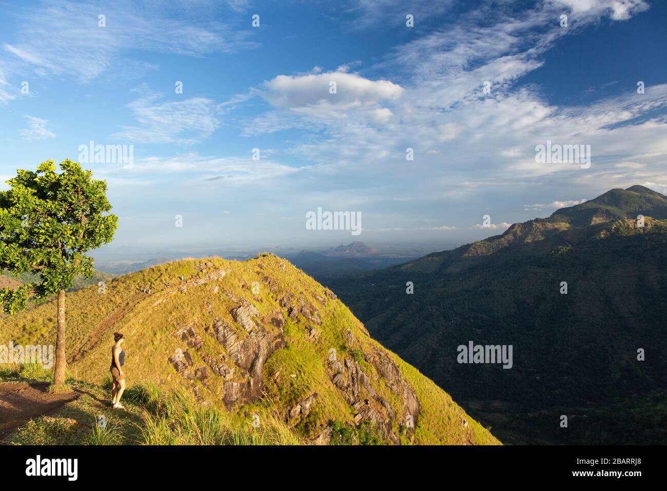 Girl standing on the summit of Little Adam's Peak at Ella in the Hill Country of Sri Lanka Stock Photo