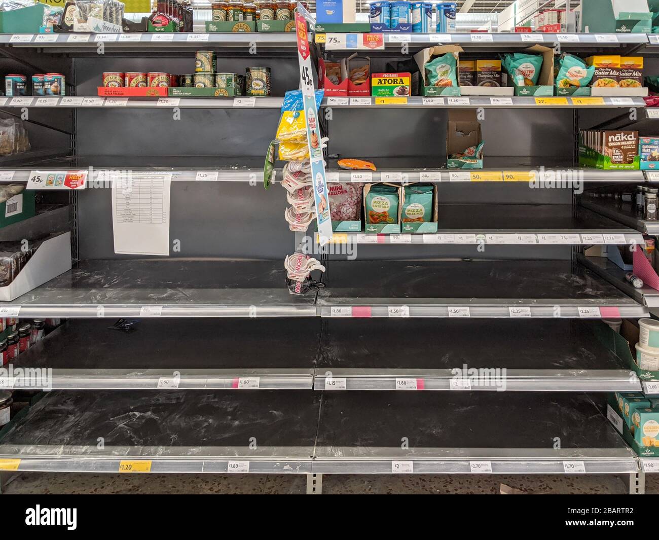 Flour aisle empty in Morrisons supermarket as shoppers wipe out some food section as panic buy Stock Photo