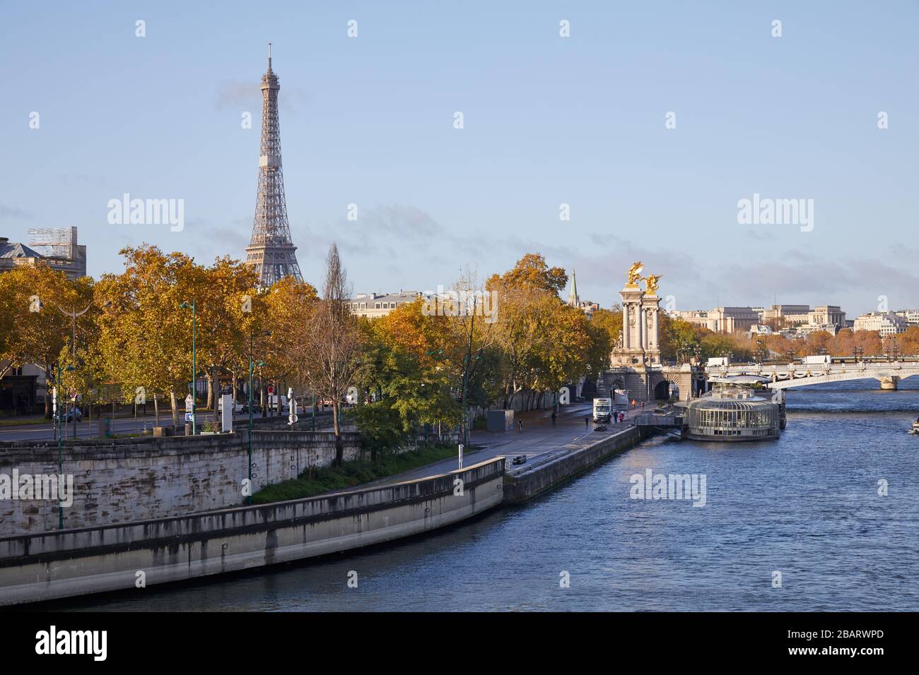 Seine river view with docks, Eiffel tower and Alexander III bridge in a sunny autumn day in Paris Stock Photo