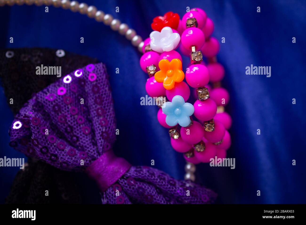 Beautiful and colourful hair clips, bracelet for kids and teens on a blue background. Stock Photo