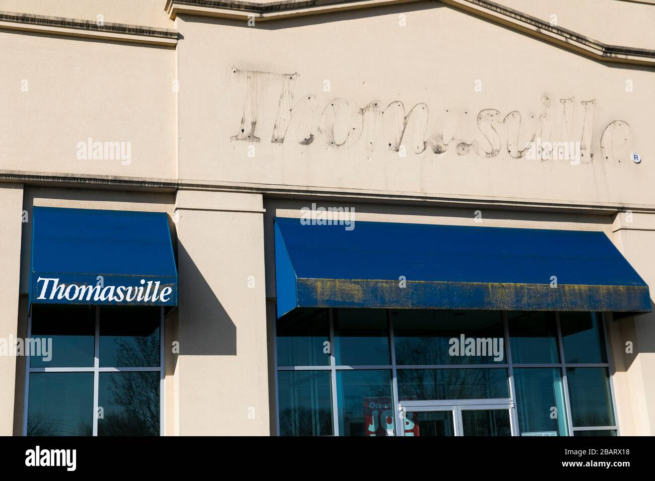 The Faded Outline Of A Thomasville Furniture Logo Sign Outside Of