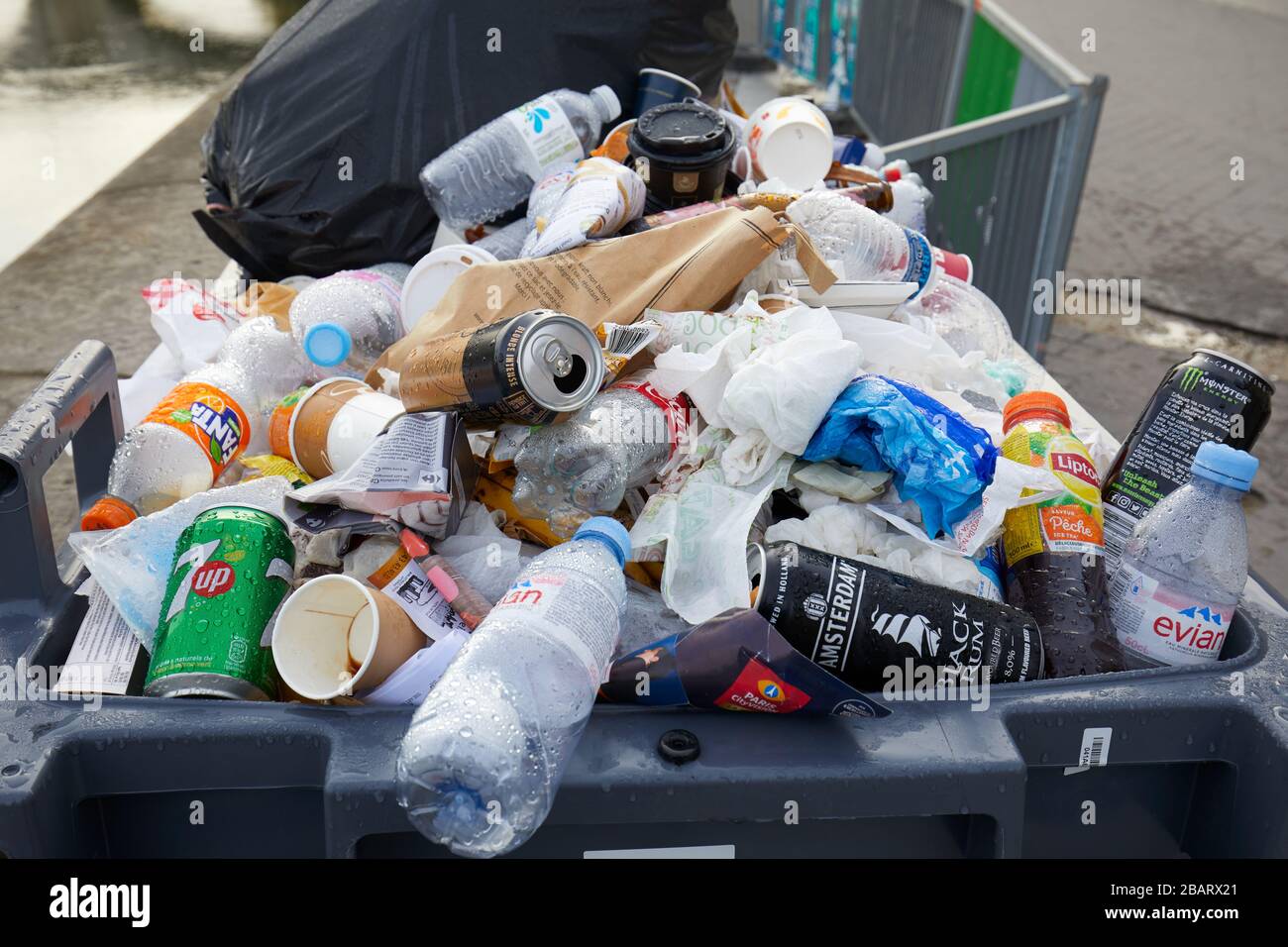PARIS - NOVEMBER 8, 2019: Full trash bin with colorful rubbish in Paris Stock Photo