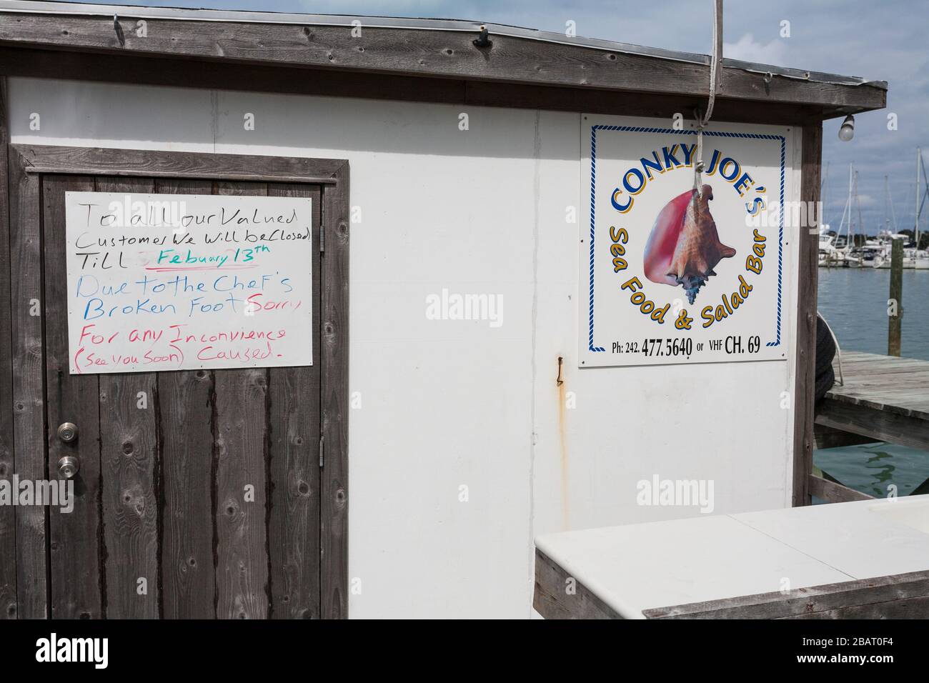 Closed: Chef's Broken Foot: A hand written sign explaining that a restaurant's chef has broken his foot so that they're closed. Stock Photo