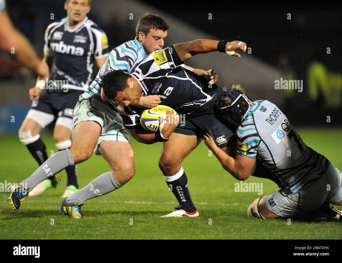 Sale Shark's Manusamoa Tuilagi is tackled by Leicester Tigers' George Ford and  Richard Thorpe Stock Photo