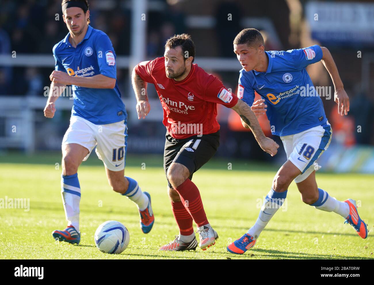 Peterborough United's George Boyd (left) and Kane Ferdinand (right) with Nottingham Forest's Andy Reid Stock Photo