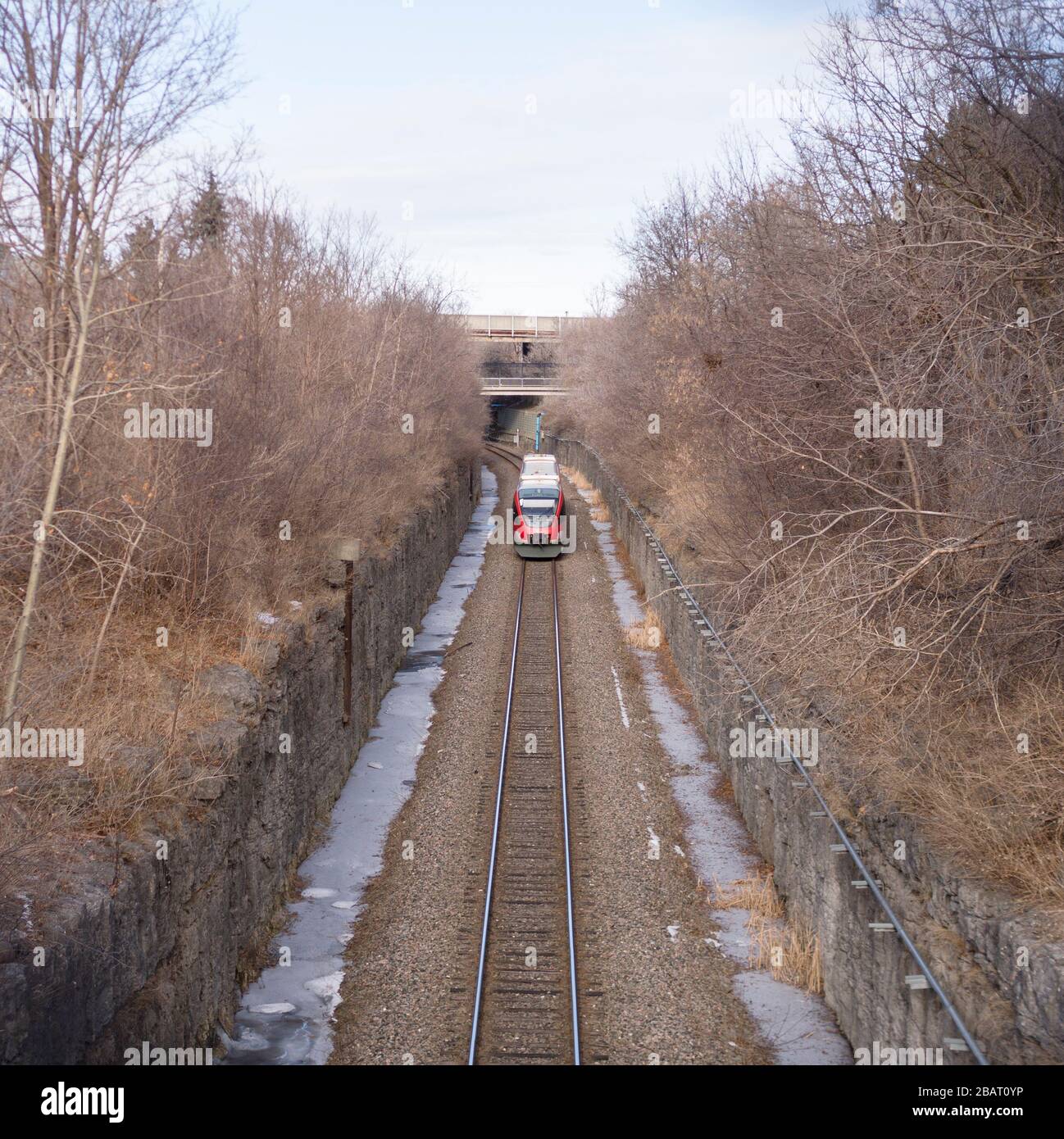 Ottawa's O-Train in a cut: Ottawa's deisel-based O-Train provided limited service on an old train track bed before being superceeded by the electric light rail system in 2019. Stock Photo