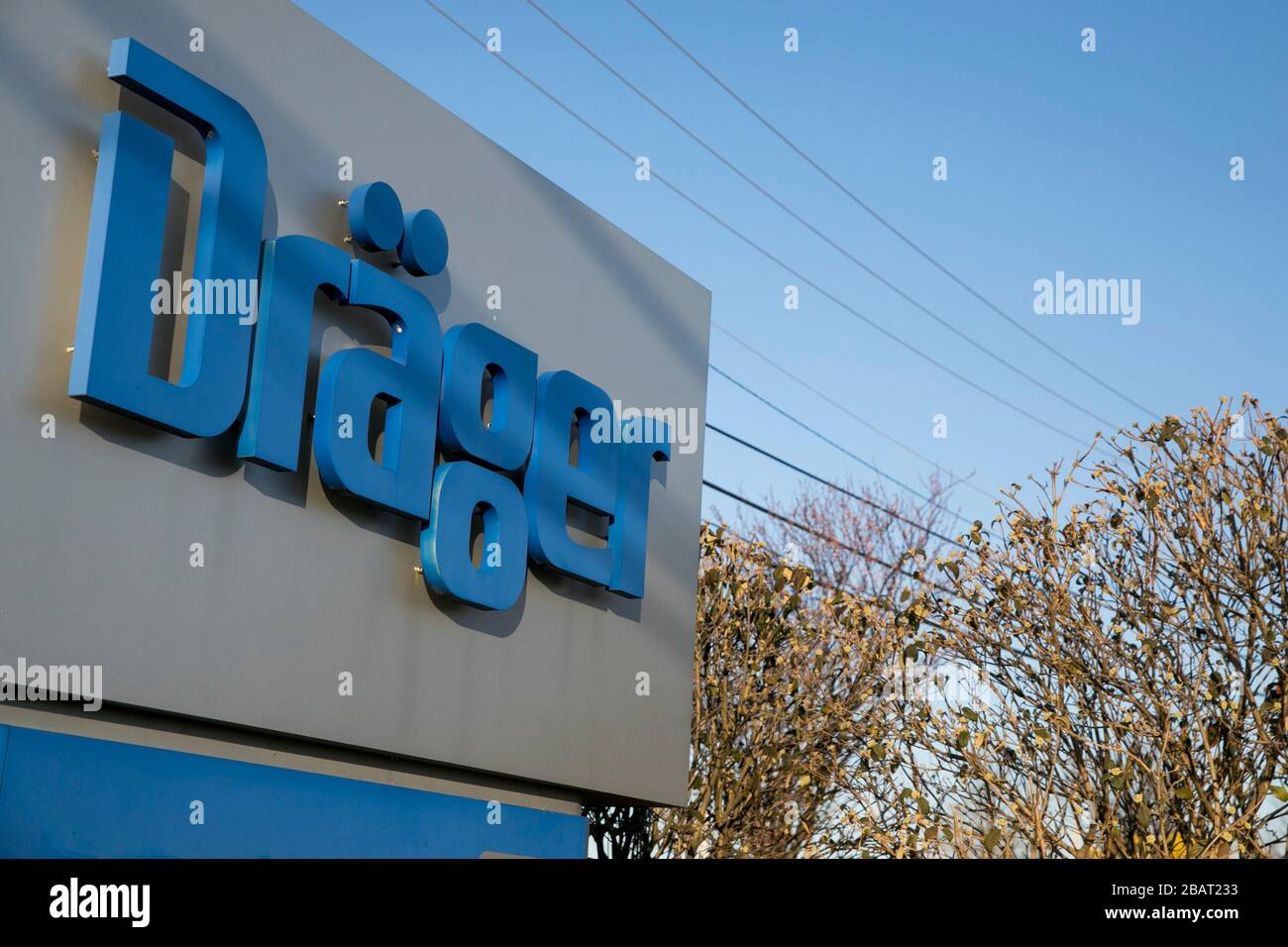 A logo sign outside of a facility occupied by Drägerwerk AG (Dräger) in