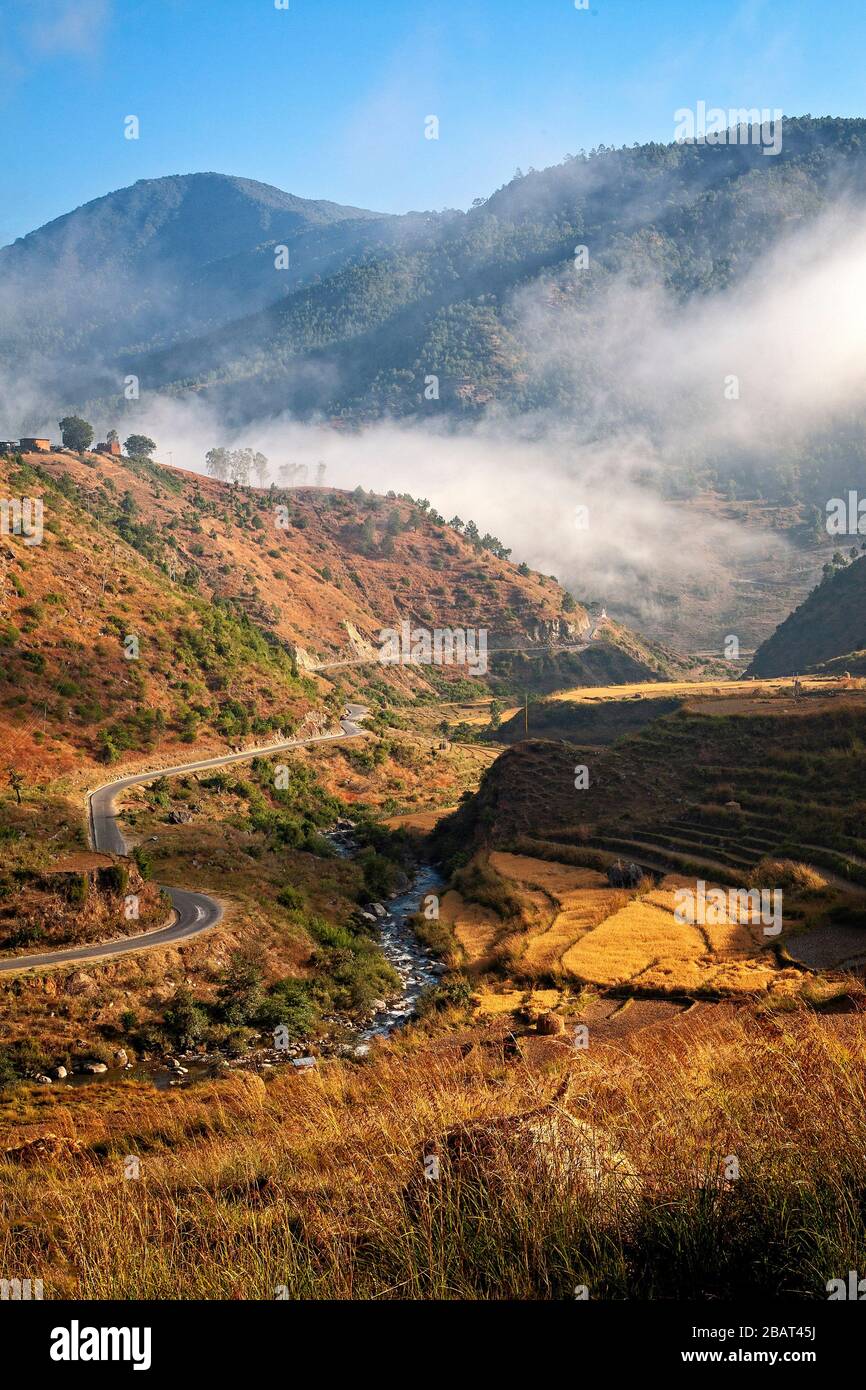 The road to the old capitol of Punakha in the foothills of the Himalaya in Bhutan. Stock Photo