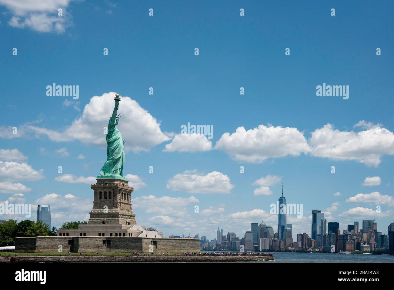 View of Statue of Liberty with Manhattan in the Background Stock Photo