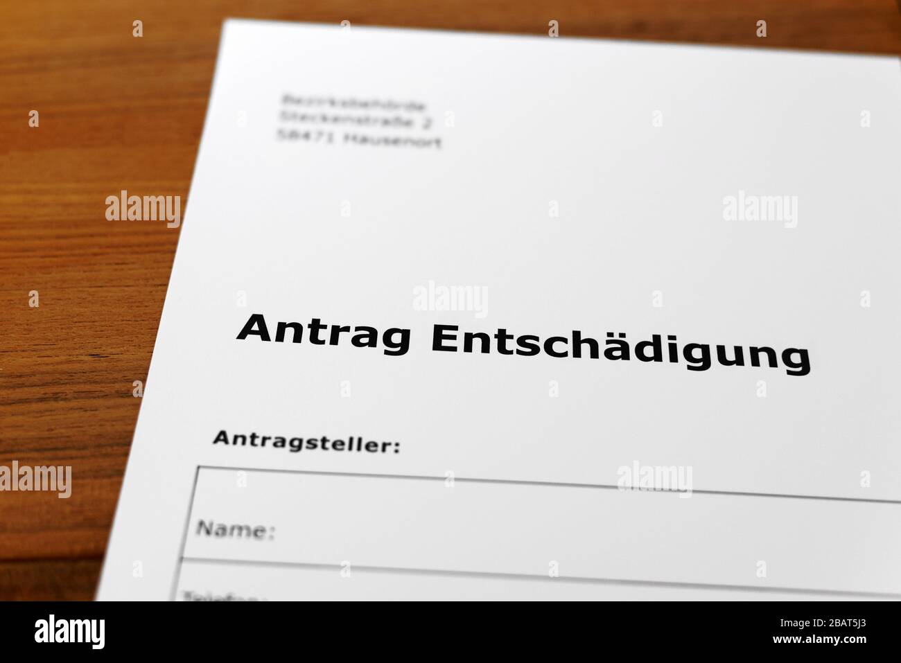 A sheet of paper with the german words 'Antrag Entschädigung' - Translation in englisch: Application for compensation Stock Photo