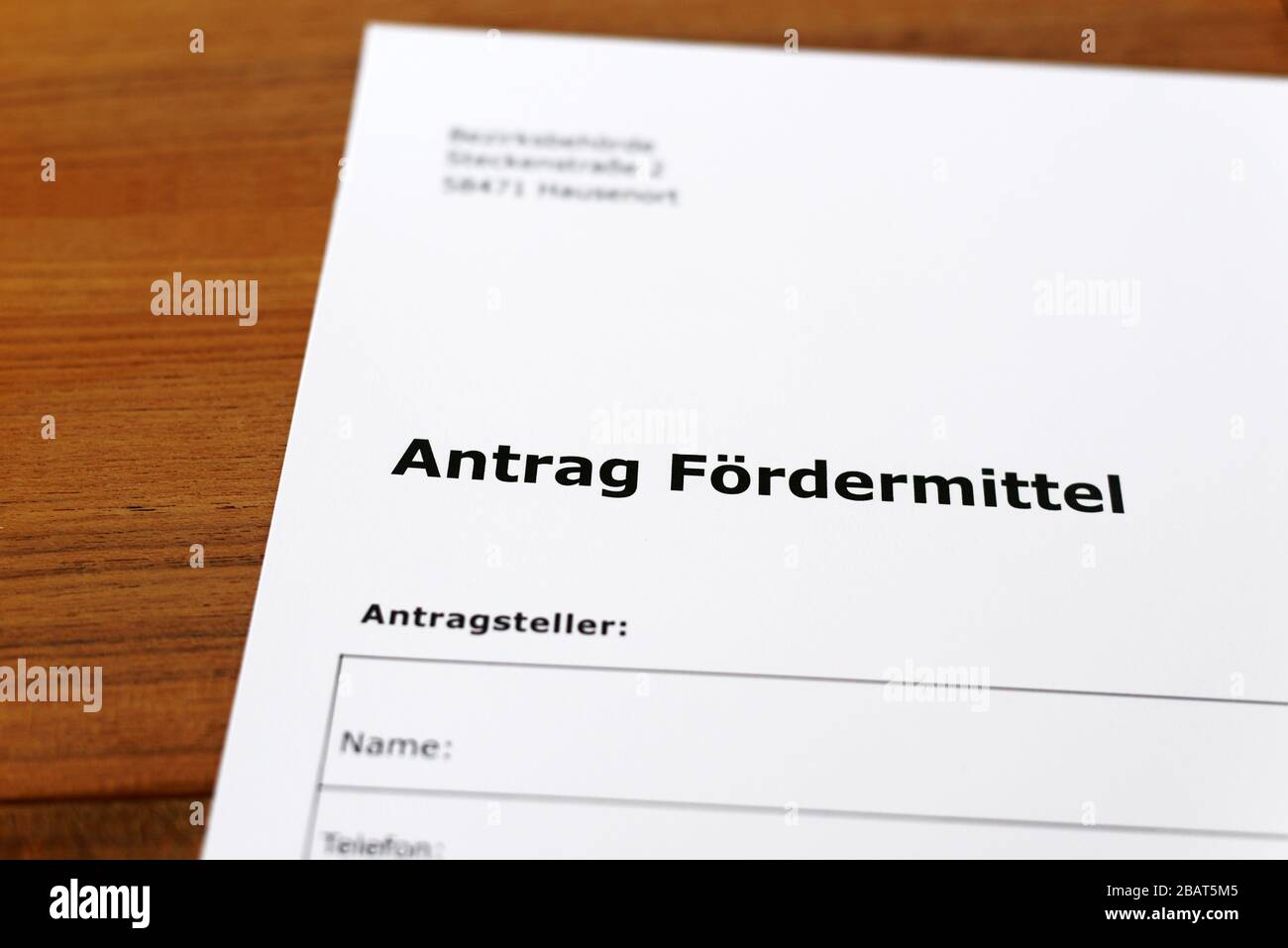 A sheet of paper with the german words 'Antrag Fördermittel' - Translation in englisch: Application for funding. Stock Photo