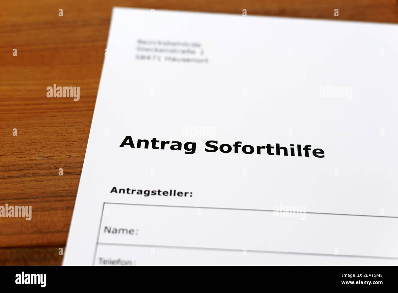 A sheet of paper with the german words 'Antrag Soforthilfe' - Translation in englisch: Application for immediate help. Stock Photo