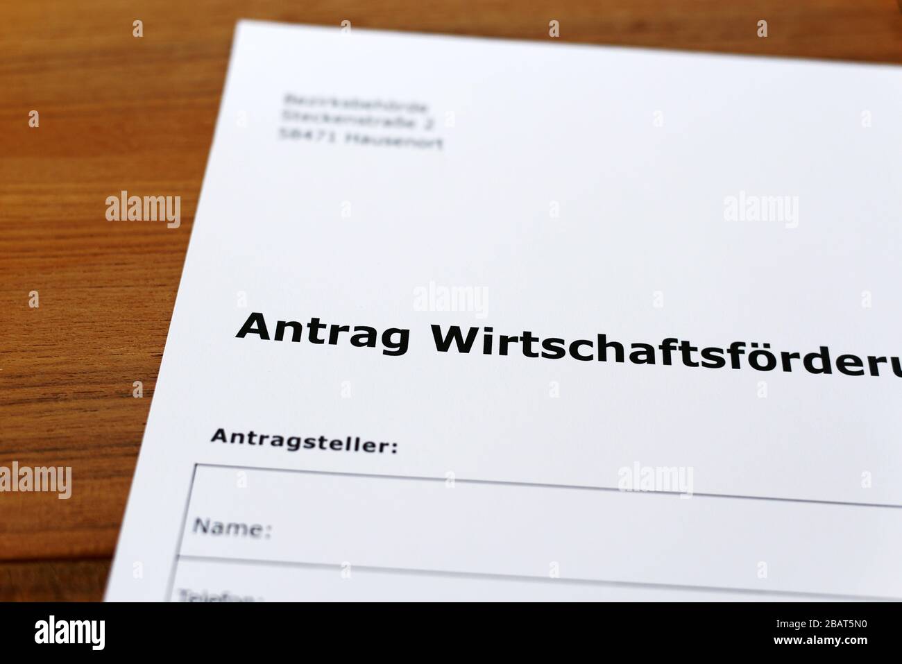 A sheet of paper with the german words 'Antrag Wirtschaftsförderung' - Translation in englisch: Application for business development. Stock Photo