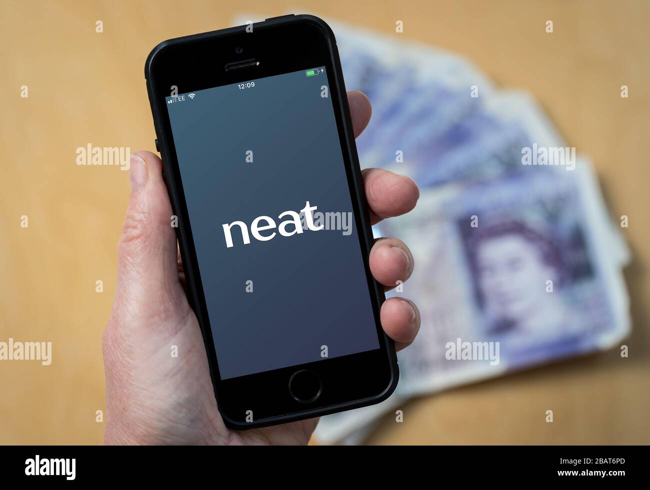 A woman using the neat accounting app on a mobile phone. (Editorial Use Only) Stock Photo