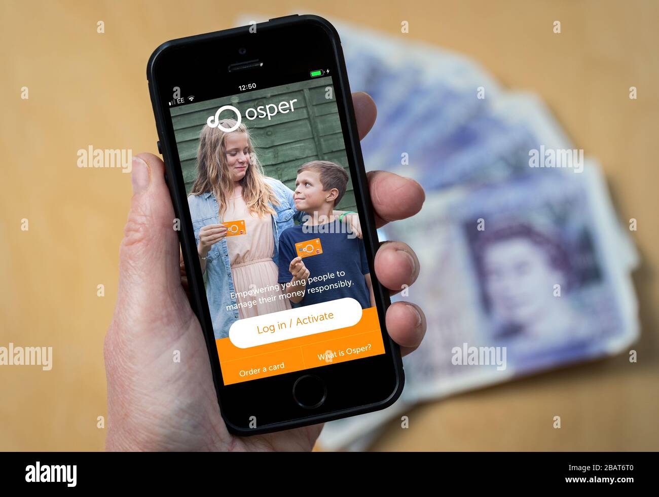 A mum using the Osper pocket money app on a mobile phone. (Editorial Use Only) Stock Photo